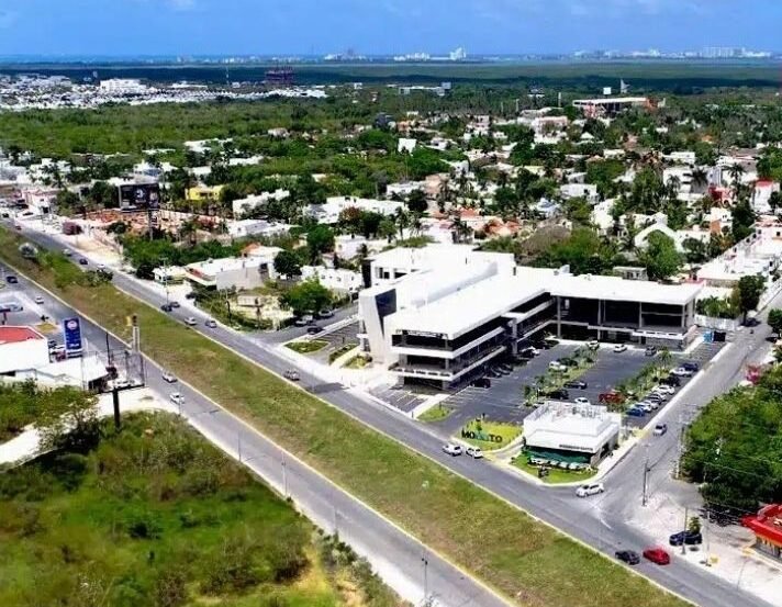 Aerial view of mixed-use real estate development in Cancún showing residential and commercial buildings
