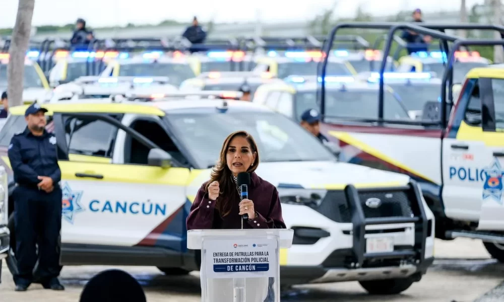 Governor Mara Lezama stands with new police vehicles during a security equipment delivery ceremony in Cancún, Mexico