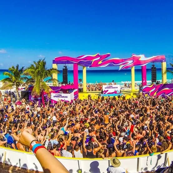 A crowded beach scene in Cancún during Spring Break