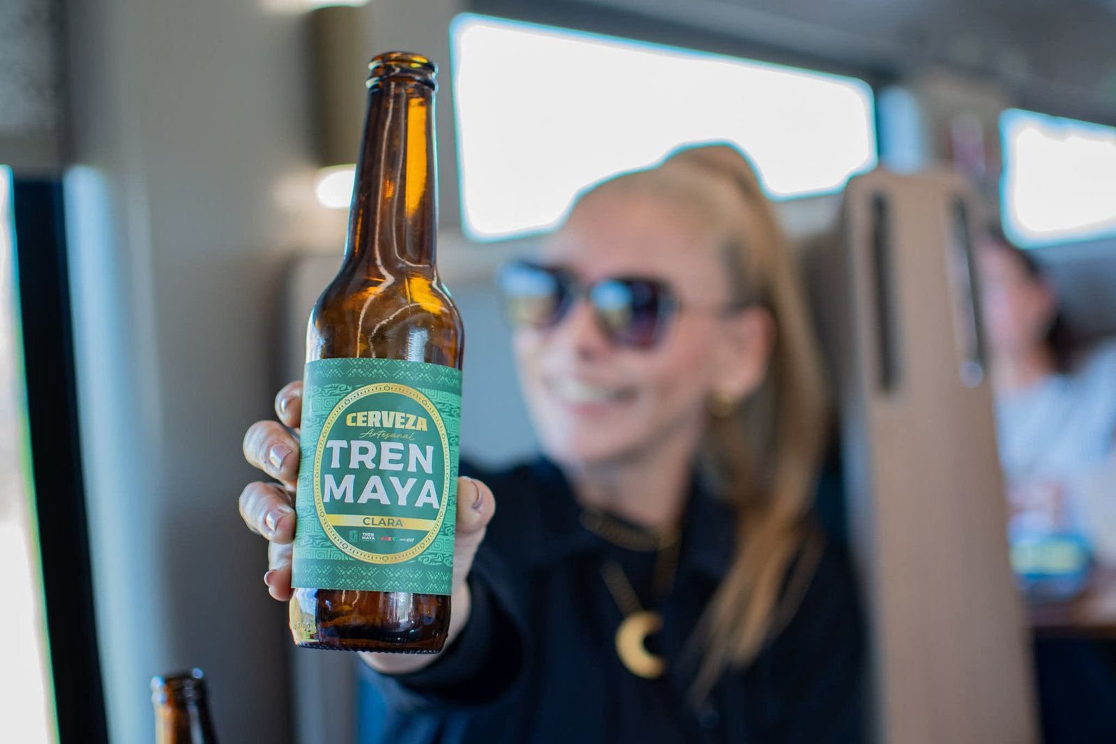 Bottles of Cerveza Tren Maya craft beer displayed against a backdrop