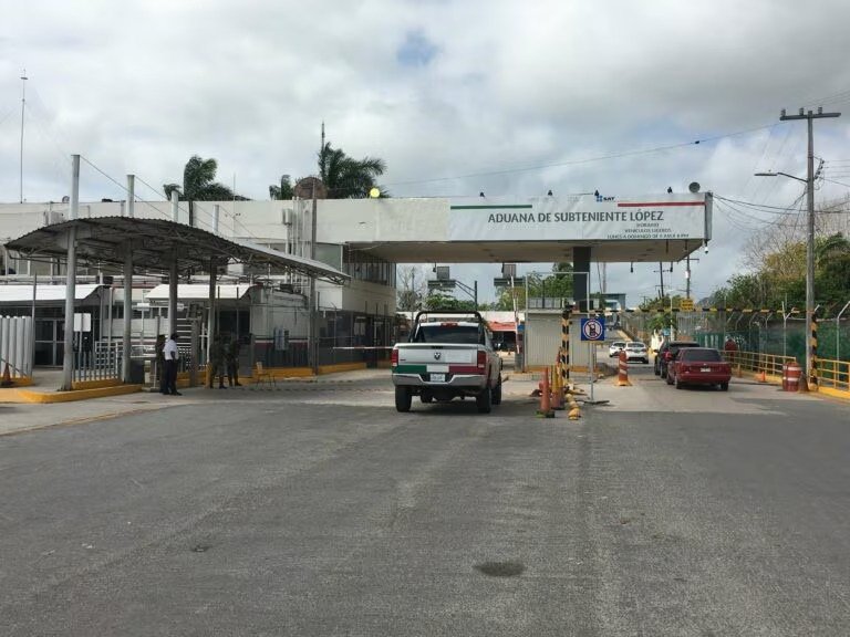 Aerial view of long vehicle lines at the Mexico-Belize border crossing near Chetumal