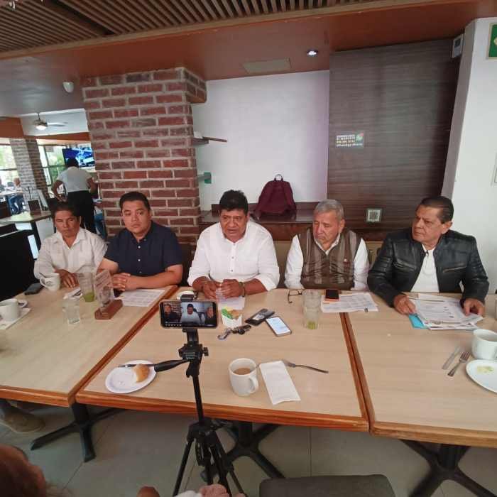 Representatives from civil and union organizations speak at a press conference in Cancun about high electricity costs.