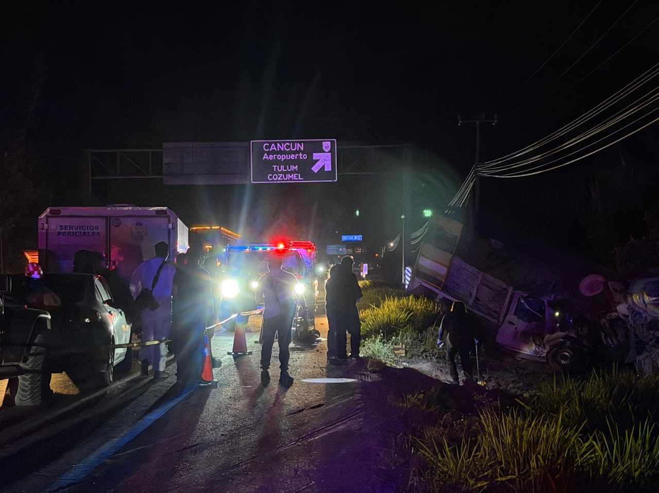 Emergency responders at the scene of a head-on collision between a white Nissan pickup and a concrete mixer truck near the Maya Train station in Cancun.