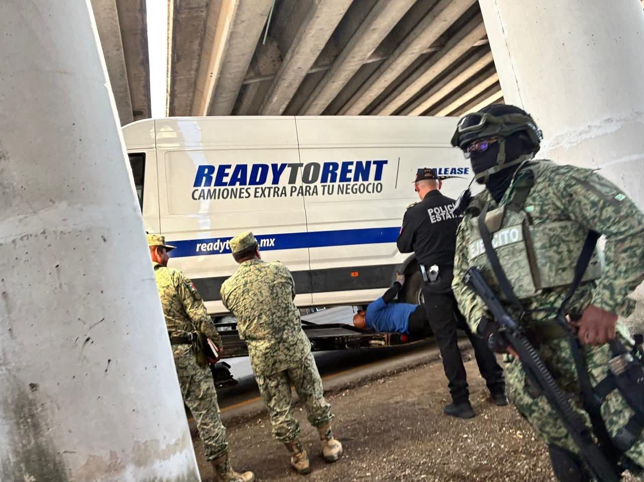 Law enforcement officers conducting a drug seizure operation on a highway near Cancún