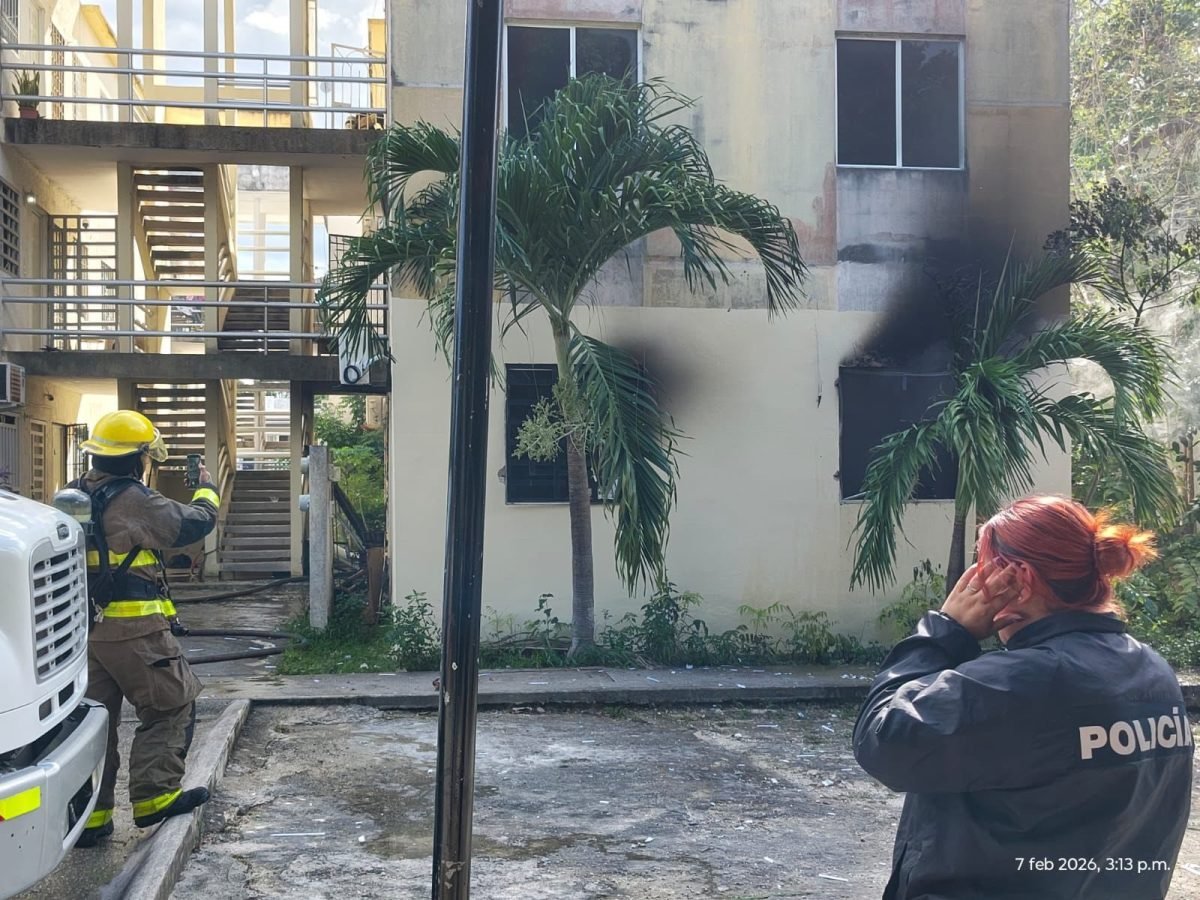 Emergency personnel and vehicles at the scene of a gas tank explosion in the Villas La Playa housing complex in Puerto Morelos