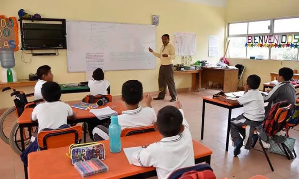 Students in a classroom learning about financial literacy in Quintana Roo