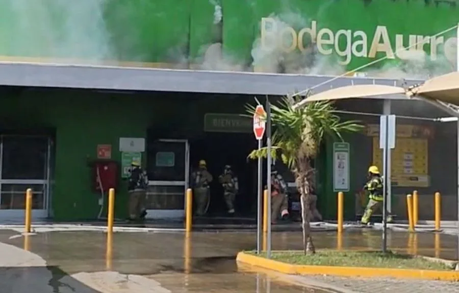 Firefighters respond to a blaze at the Bodega Aurrerá supermarket in Cozumel, Quintana Roo