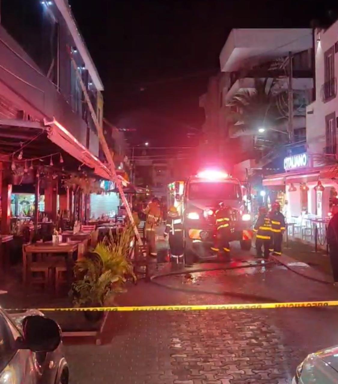 Firefighters work to extinguish a fire at the La Vaca Gaucha restaurant on Fifth Avenue in Playa del Carmen, Mexico.