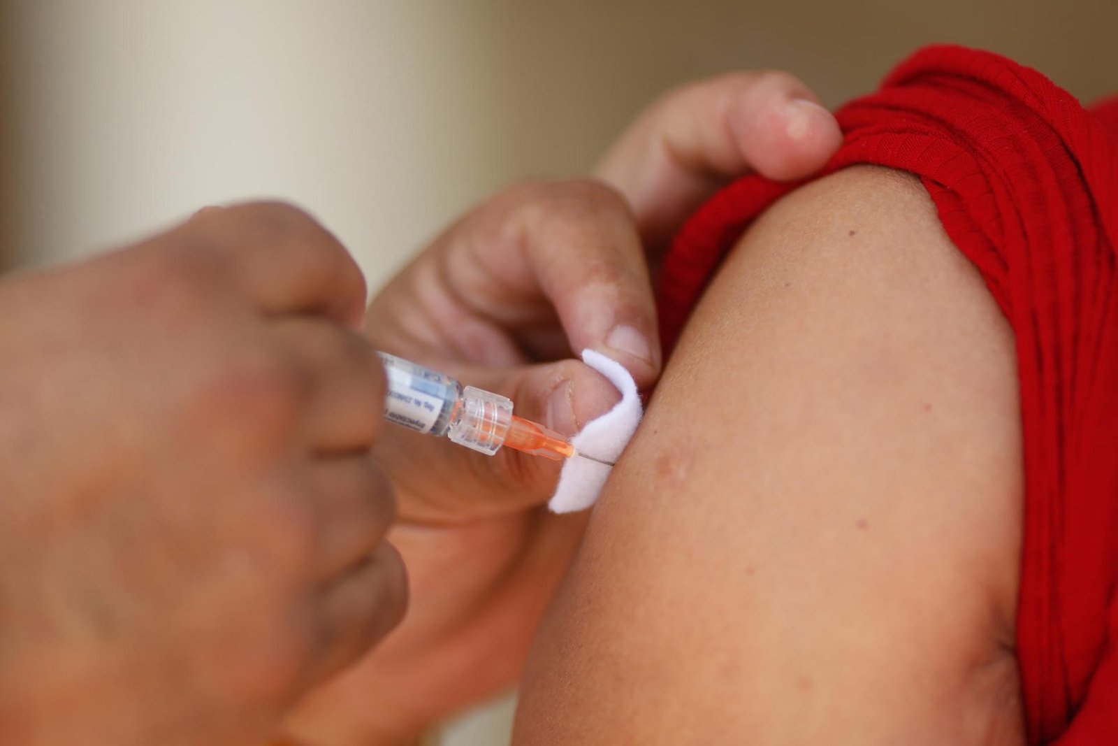 A healthcare worker administers a measles vaccine to a child in Mexico