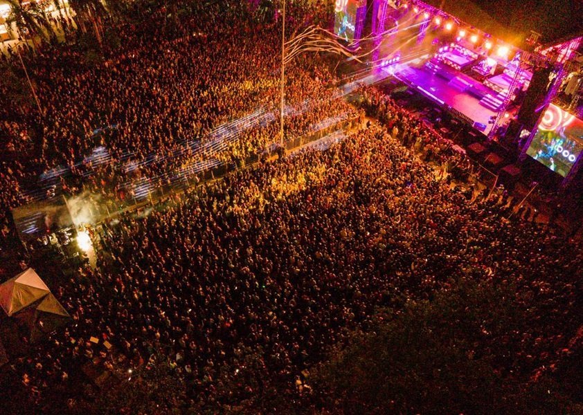 A crowd at the Playa del Carmen carnival with festive decorations