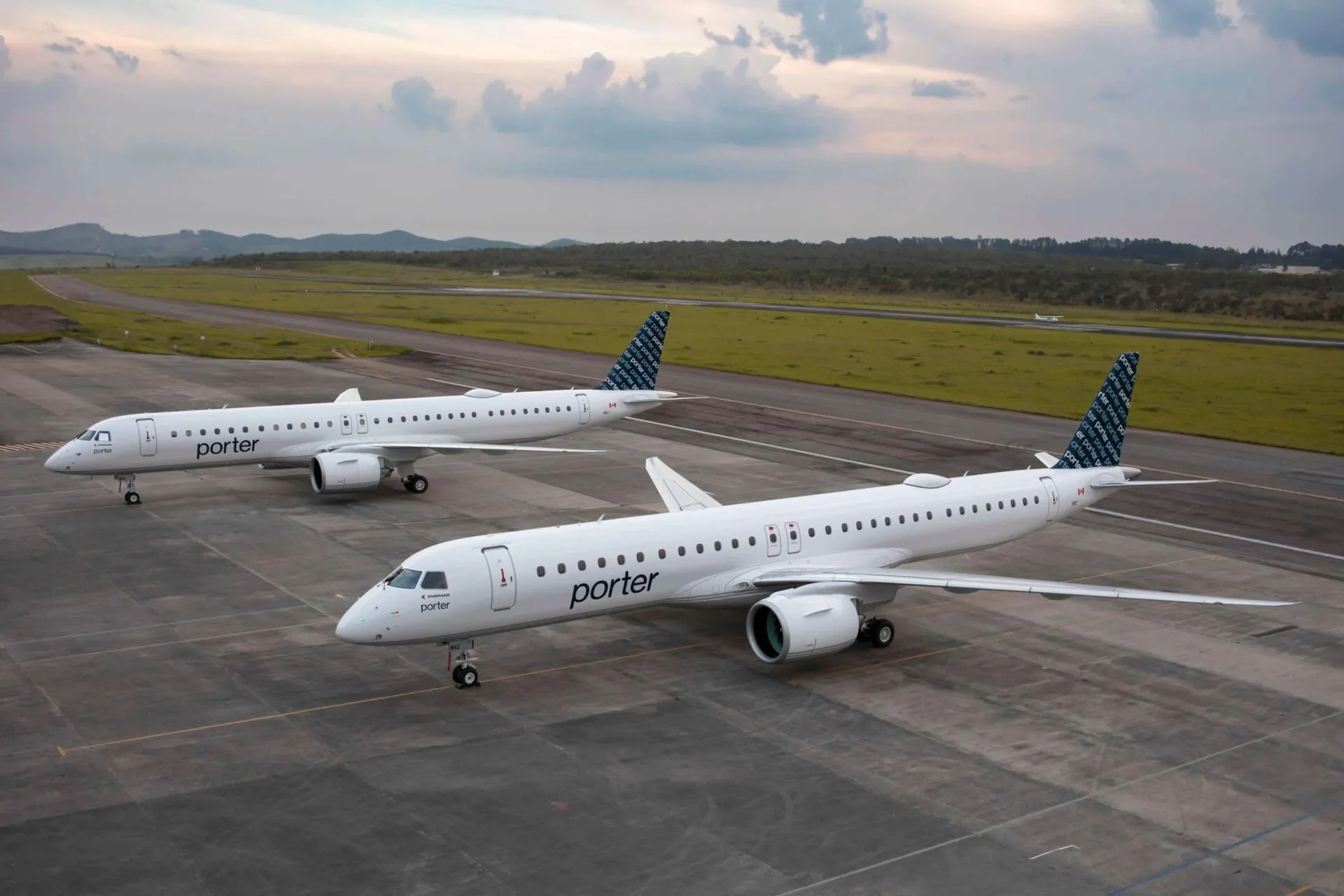 A Porter Airlines Embraer E195-E2 aircraft on the tarmac, part of the airline's fleet expansion for international routes.