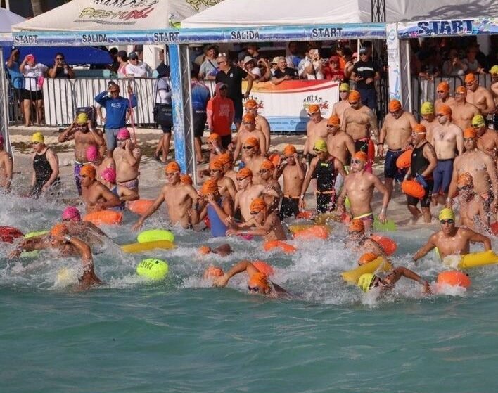 Swimmers competing in the open water marathon at Ventana al Mar beach in Puerto Morelos
