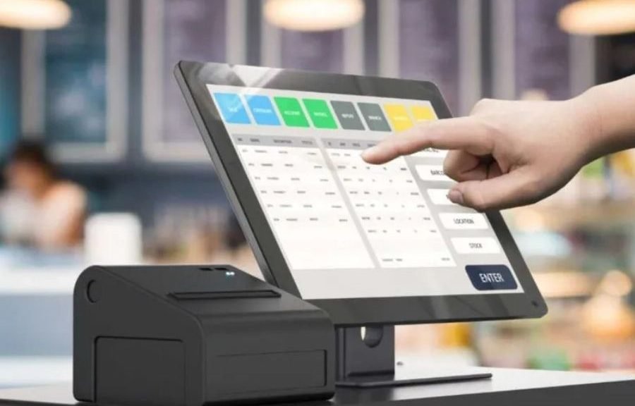 A businessperson reviewing financial documents on a laptop, representing SMEs facing AI-powered tax audits in Mexico