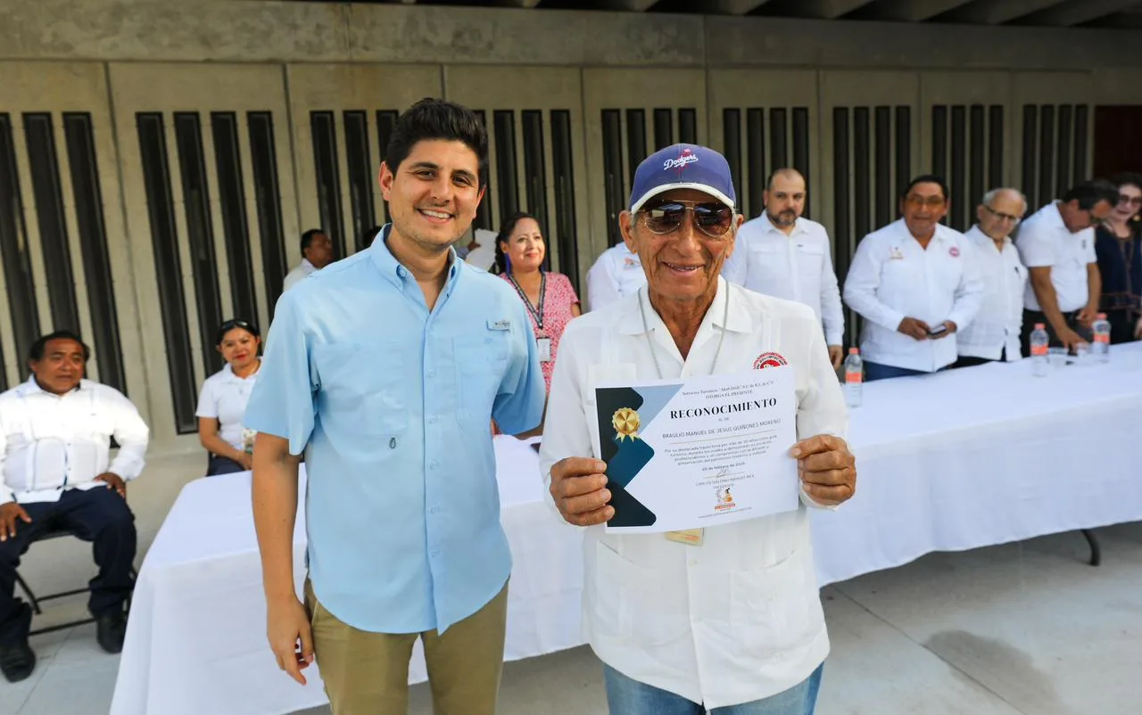 Officials and tourist guides at a recognition ceremony at Chichen Itza archaeological site