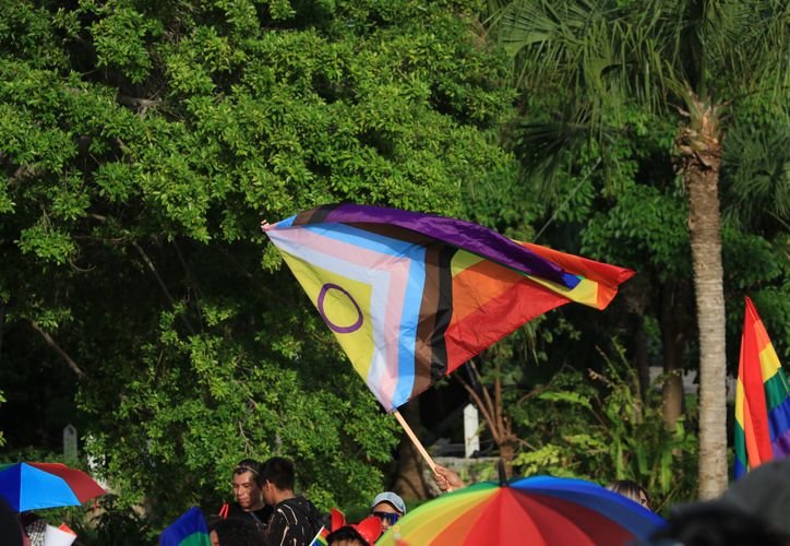 A group of transgender women holding signs during a protest against workplace discrimination