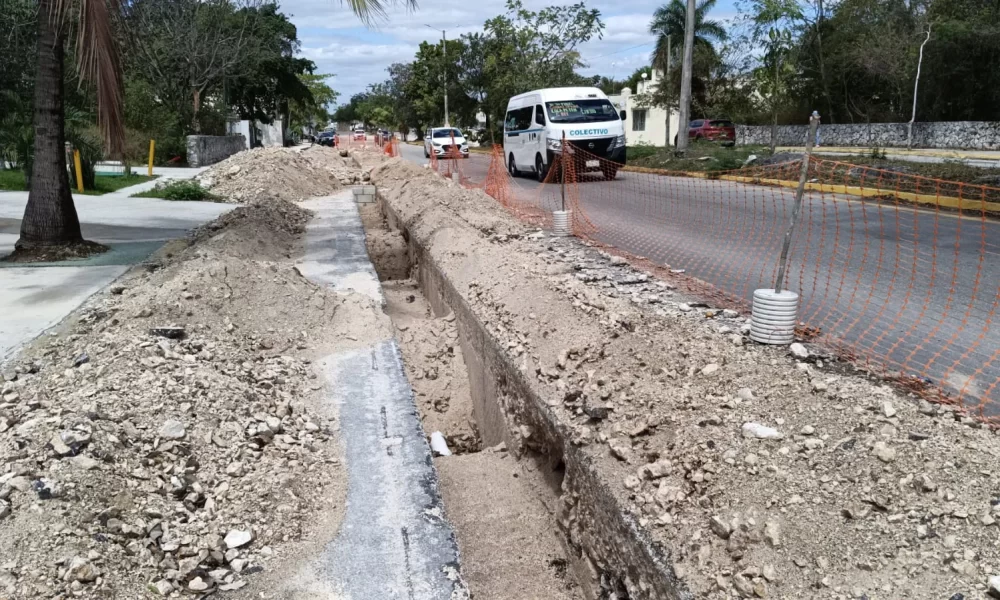 An open trench and construction materials block part of Xel-Ha Avenue in Playa del Carmen, Mexico