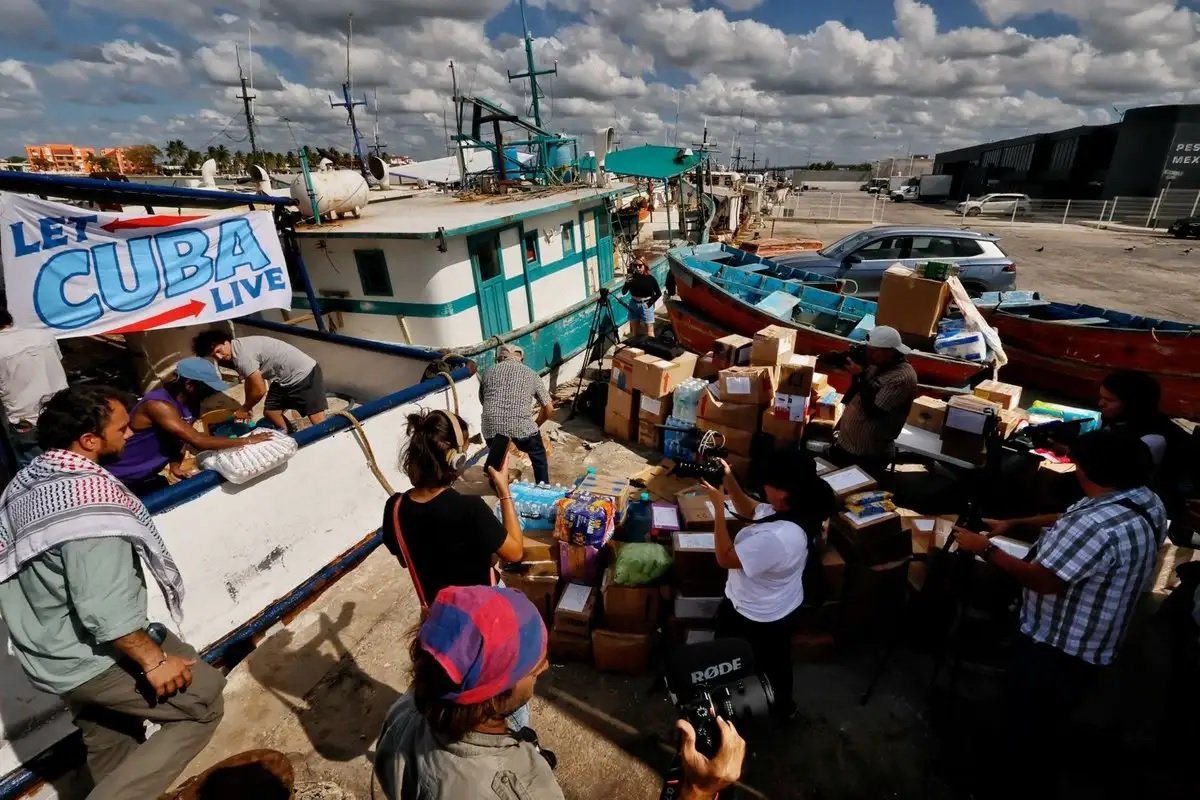 Volunteers load boxes of humanitarian aid onto a vessel in Progreso, Yucatan, bound for Cuba