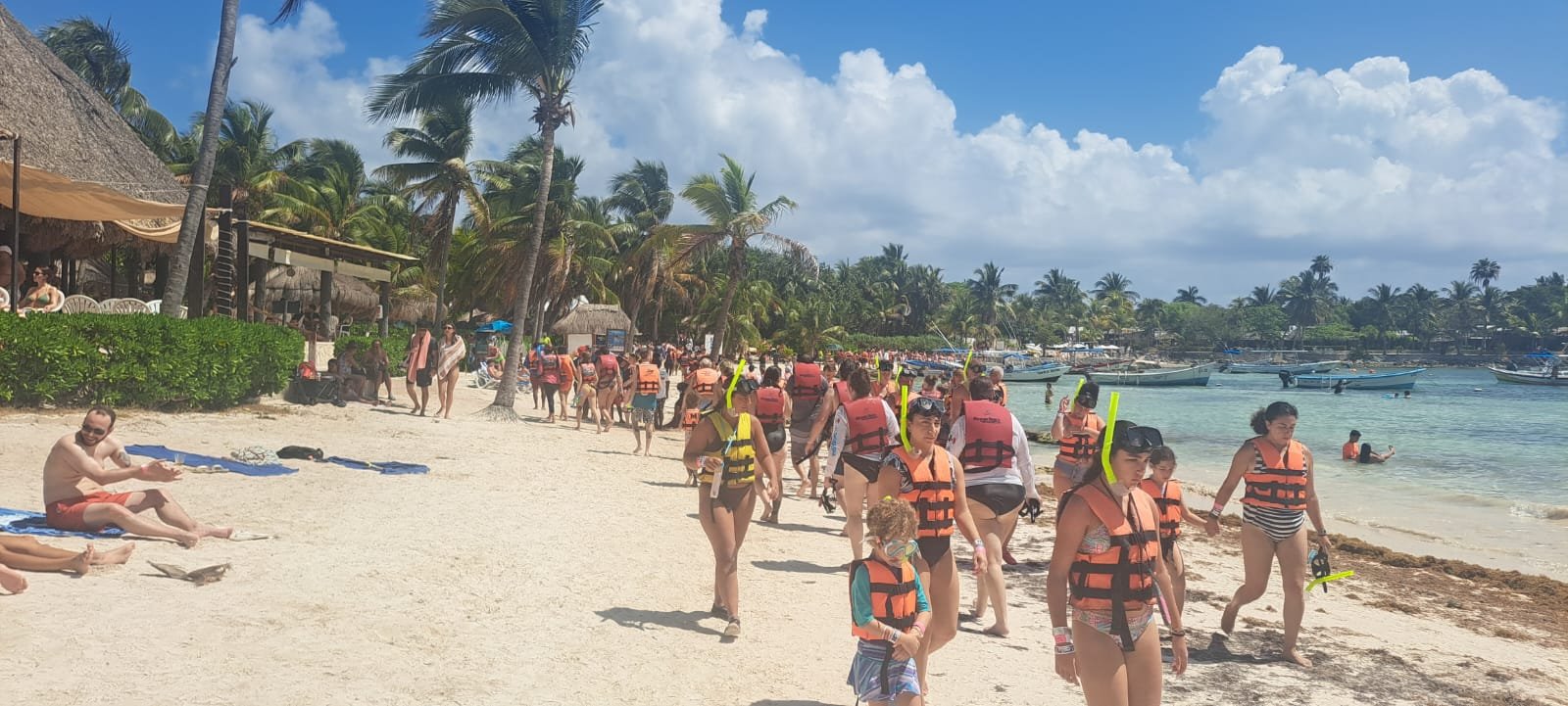 Tourists enjoying the beach and water activities in Akumal, Quintana Roo