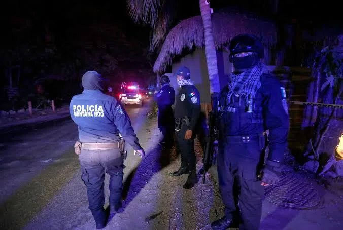 Police officers at the crime scene outside La Costera 28 restaurant in Bacalar