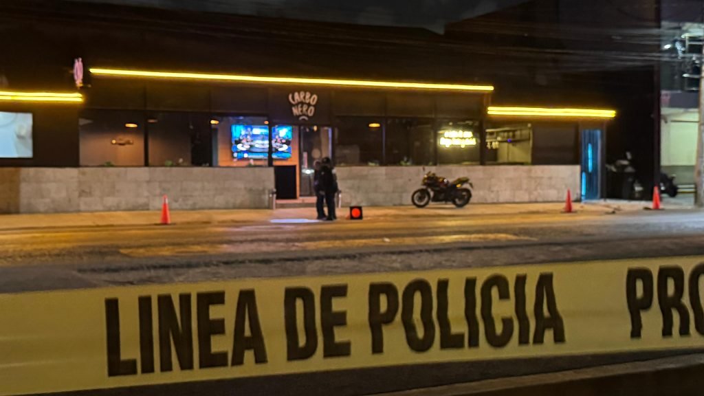 Police and emergency responders at the scene of a shooting outside El Carbonero bar in Cancún