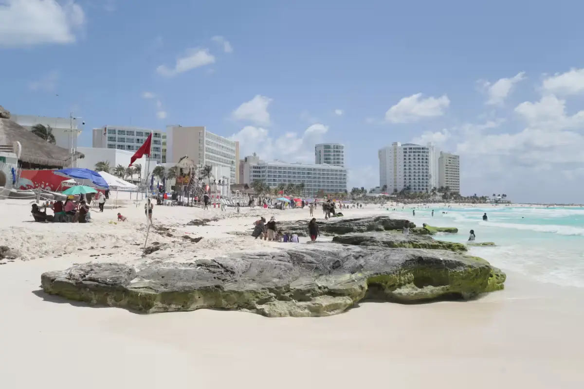 A Cancun beach with red warning flags flying as lifeguards monitor the shoreline