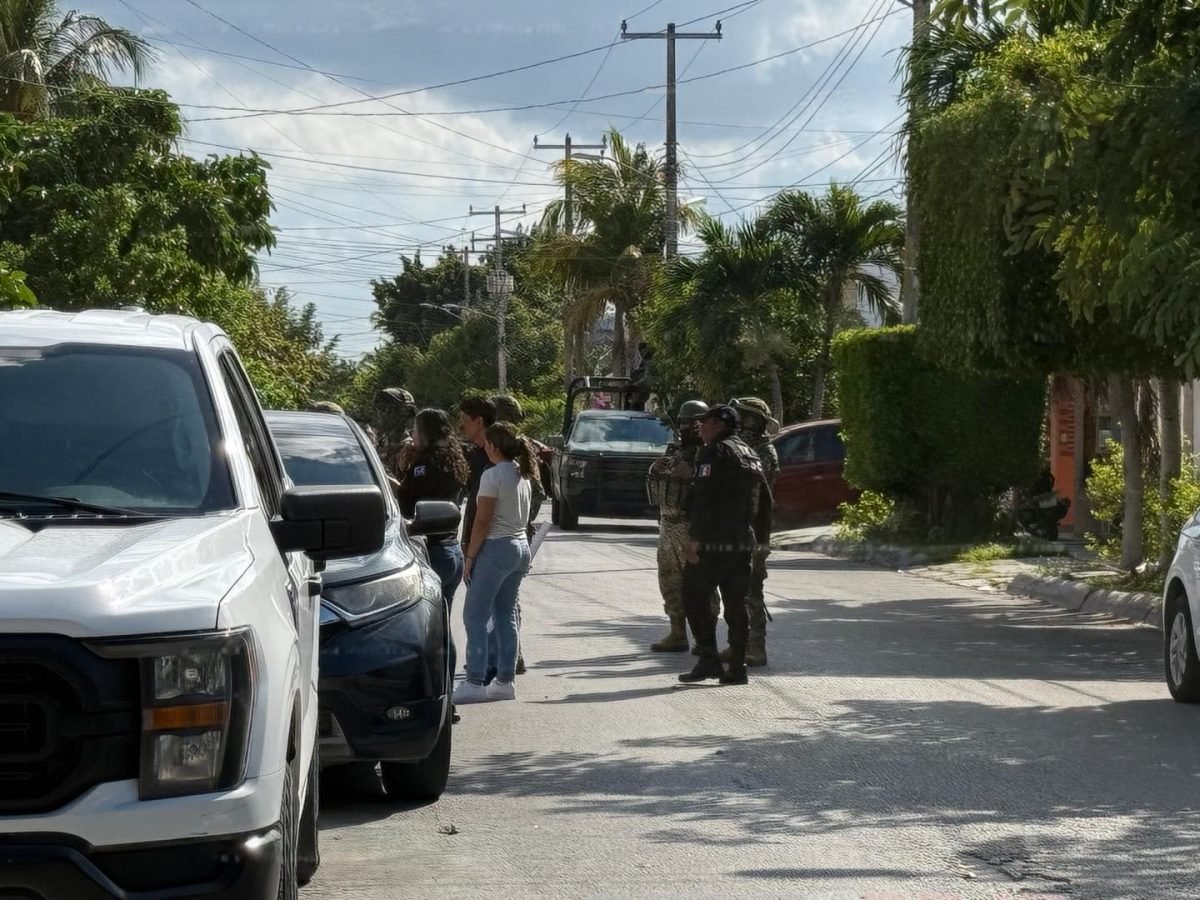 Authorities cordon off a street during a raid on a call center in Cancun's Supermanzana 45