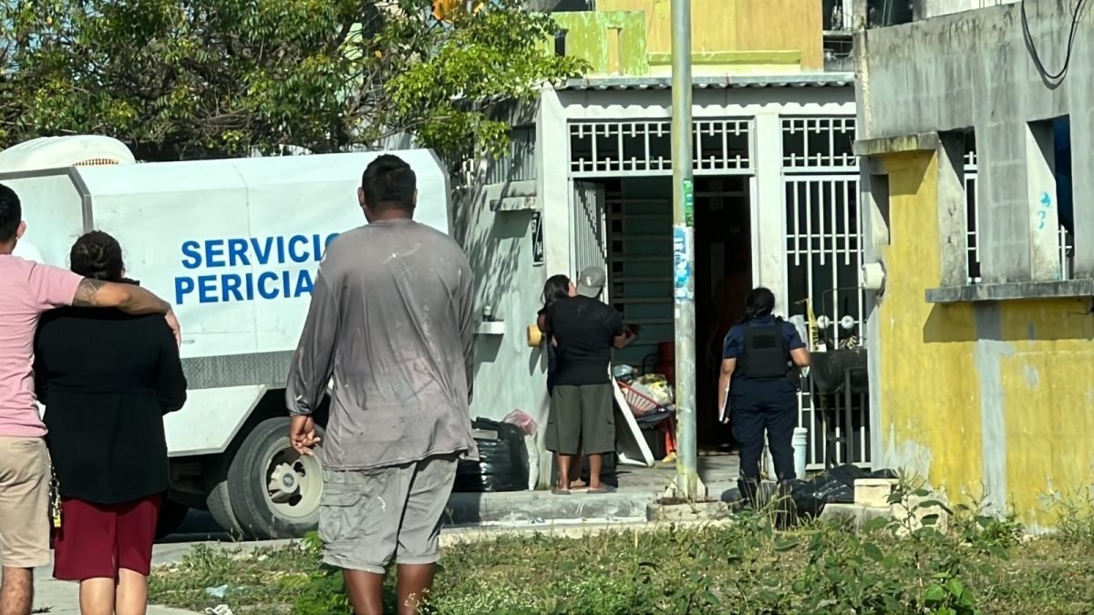 Police tape and emergency vehicles at the scene of a shooting in Cancún's Ciudad Natura neighborhood