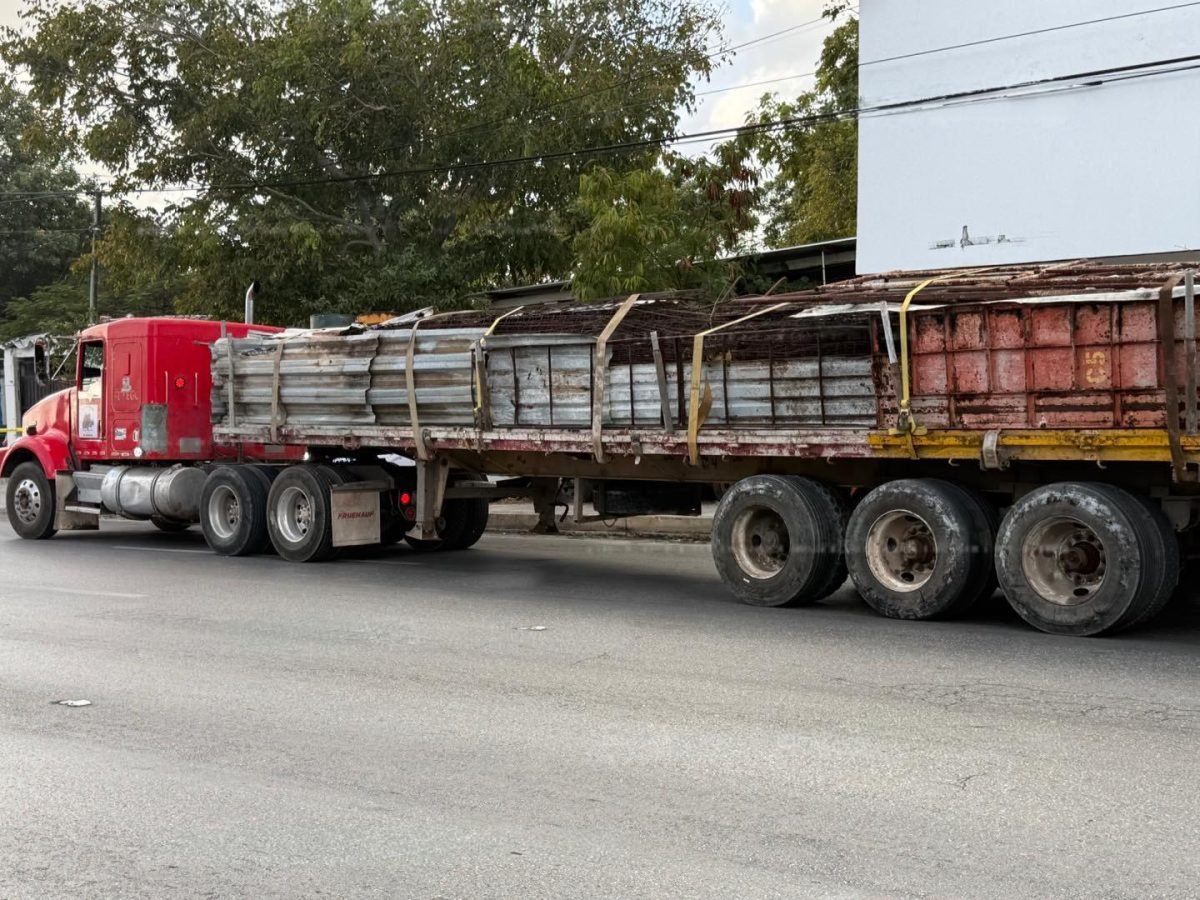 Emergency responders at the scene of a traffic accident in Cancun involving a tractor-trailer and a motorcycle