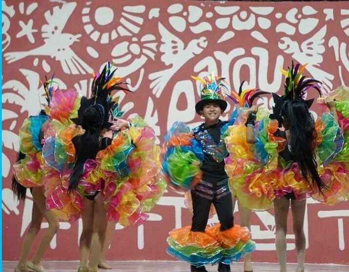 Performers dancing on stage at the Caribbean Nights event in Parque de las Palapas, Cancún