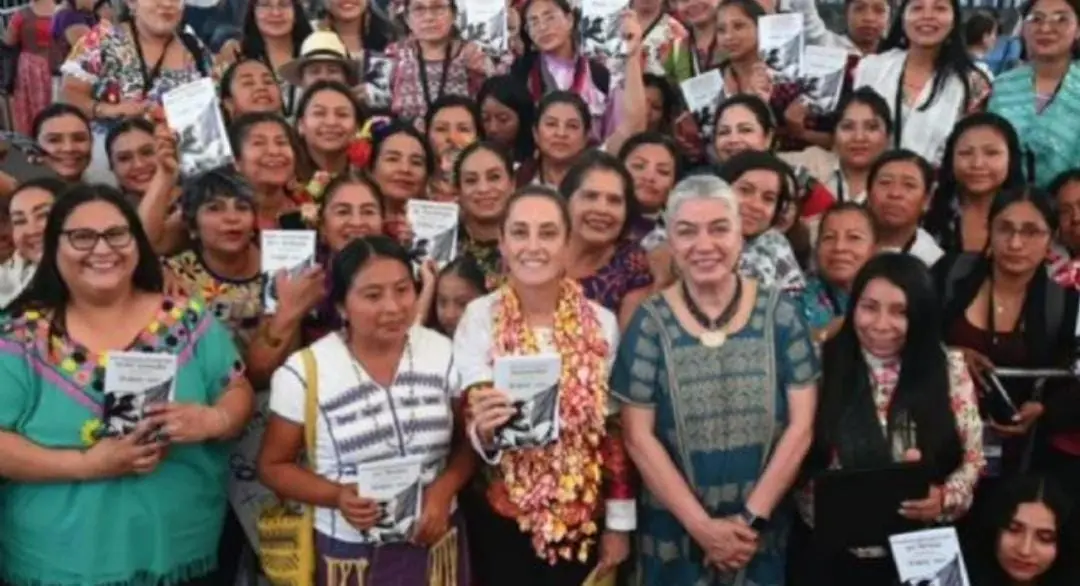 President Claudia Sheinbaum speaking at an event with indigenous translators