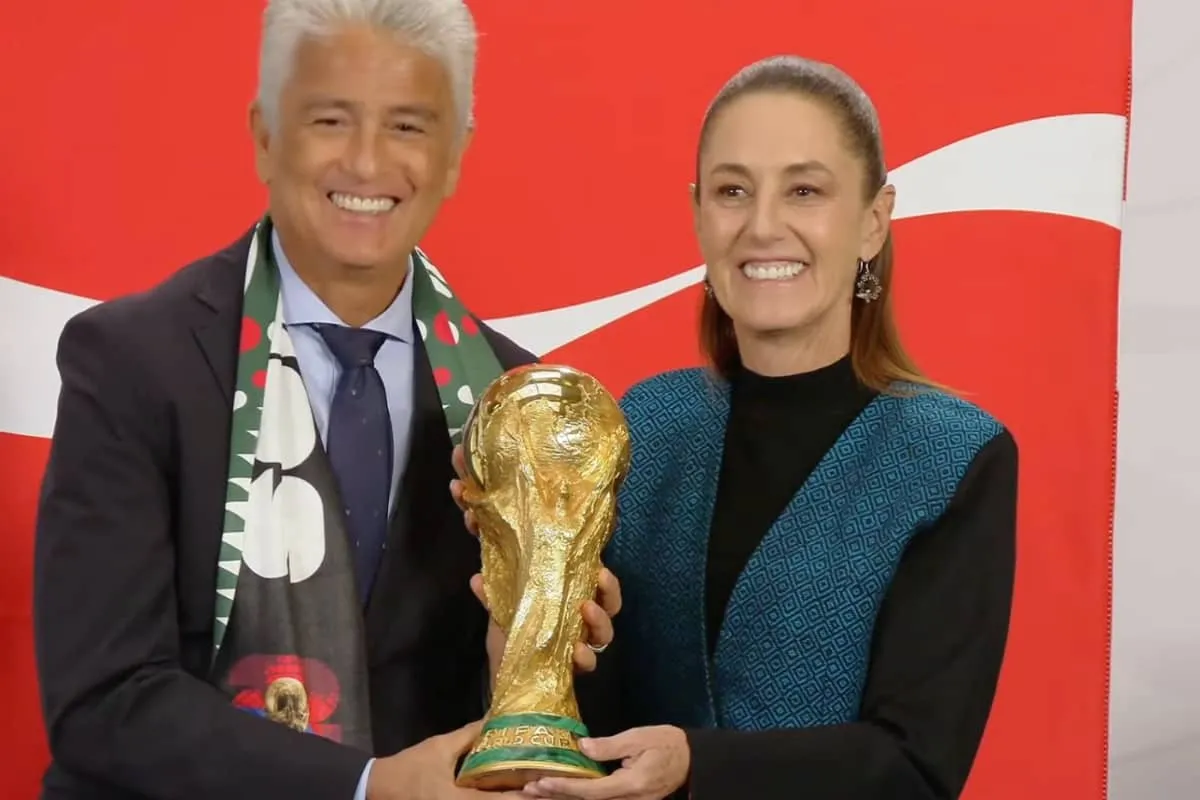 Mexican President Claudia Sheinbaum holding the FIFA World Cup trophy alongside Brazilian former player Bebeto