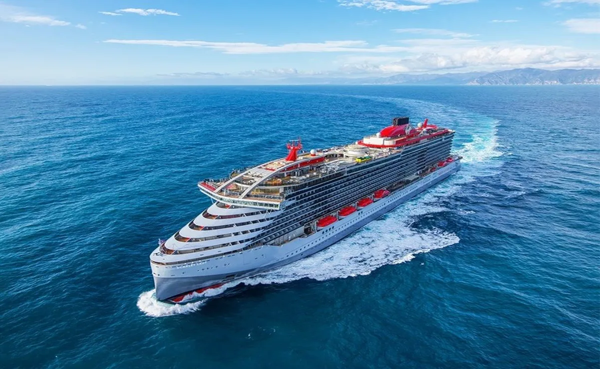 A cruise ship docked at Cozumel port with passengers disembarking