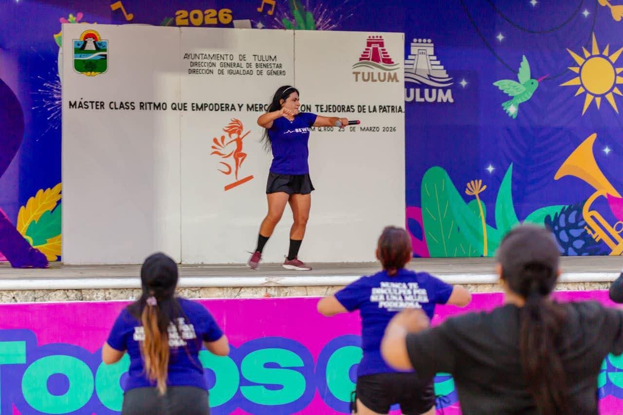 Participants engaging in a dance masterclass at an outdoor venue in Tulum, led by an instructor in athletic wear.$# CAPTION