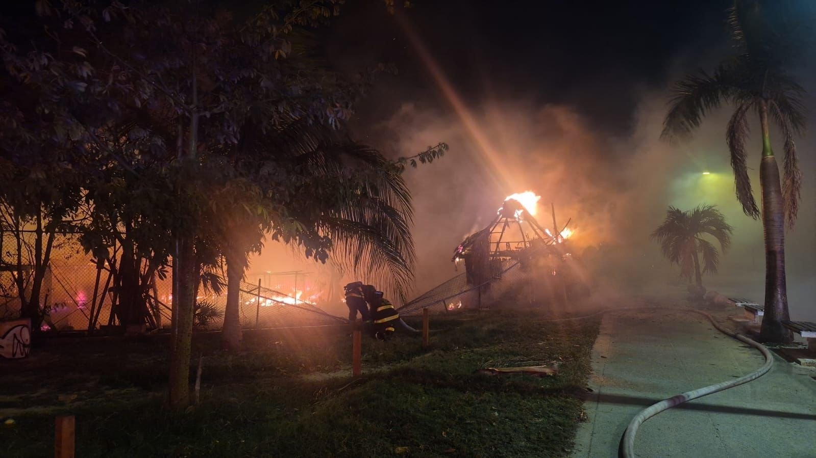 Firefighters battling a blaze that destroyed five palapas on Luis Donaldo Colosio Avenue in Playa del Carmen
