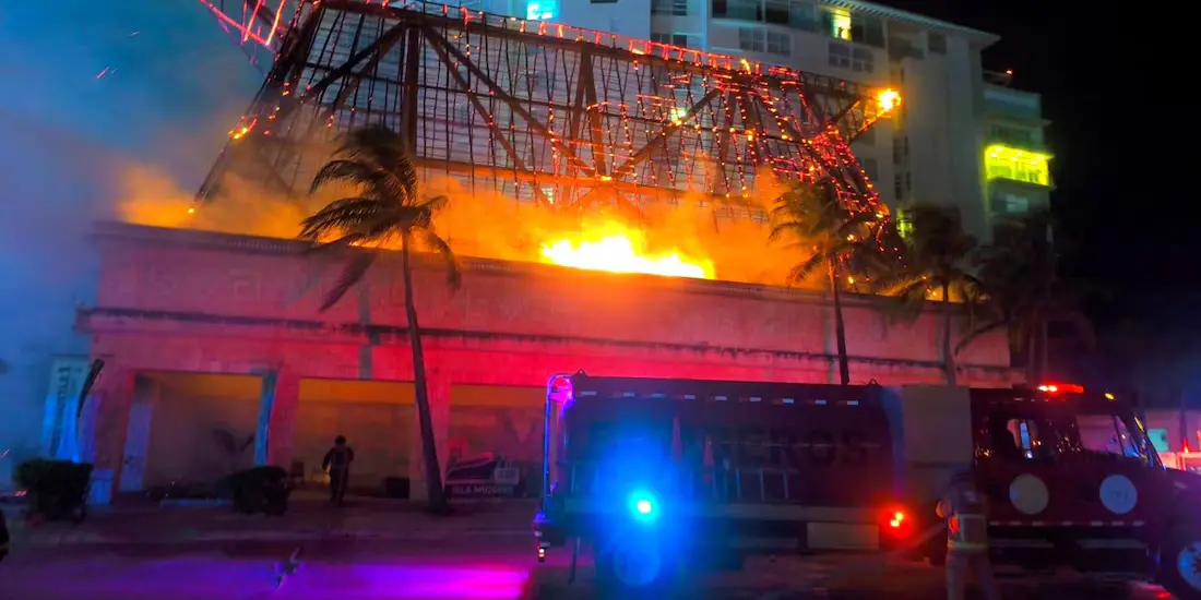 Firefighters respond to a blaze at an Xcaret base palapa in Cancún's hotel zone