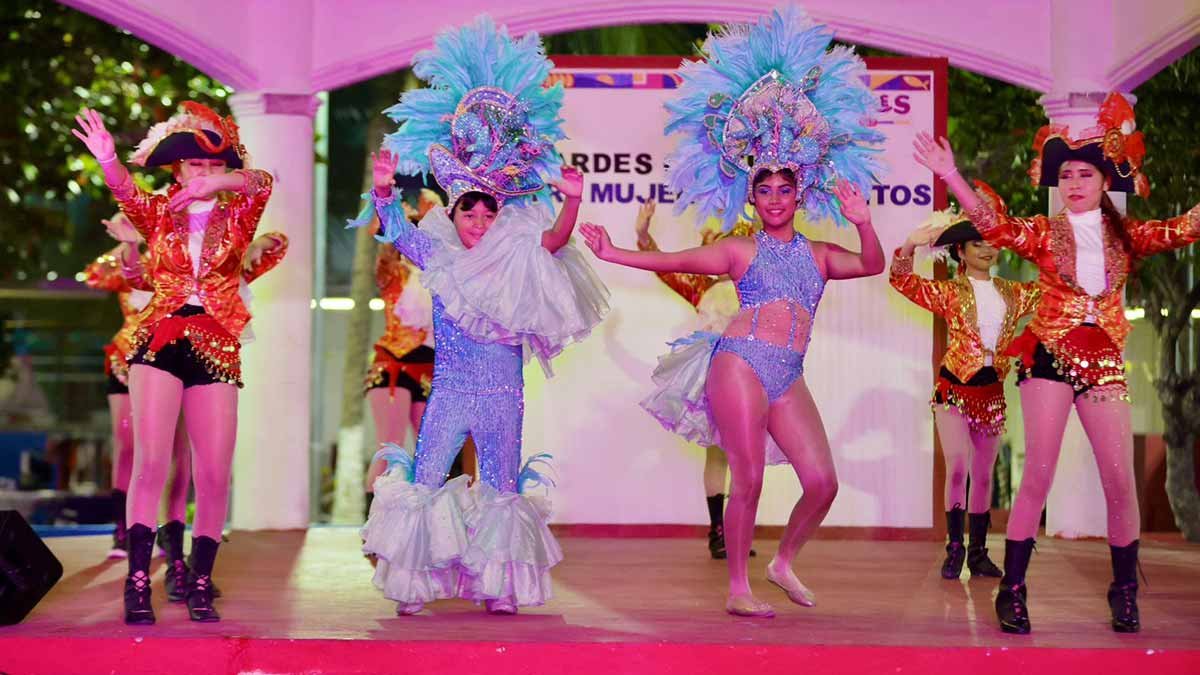 Women participating in a cultural event at a kiosk in Isla Mujeres