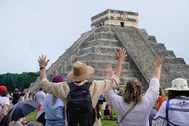 The Kukulcan pyramid at Chichen Itza with the Milky Way visible in the night sky above
