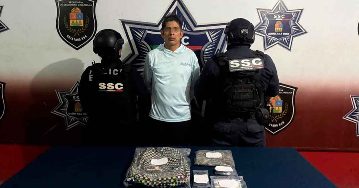 A backpack containing seized marijuana bags and a scale on a table