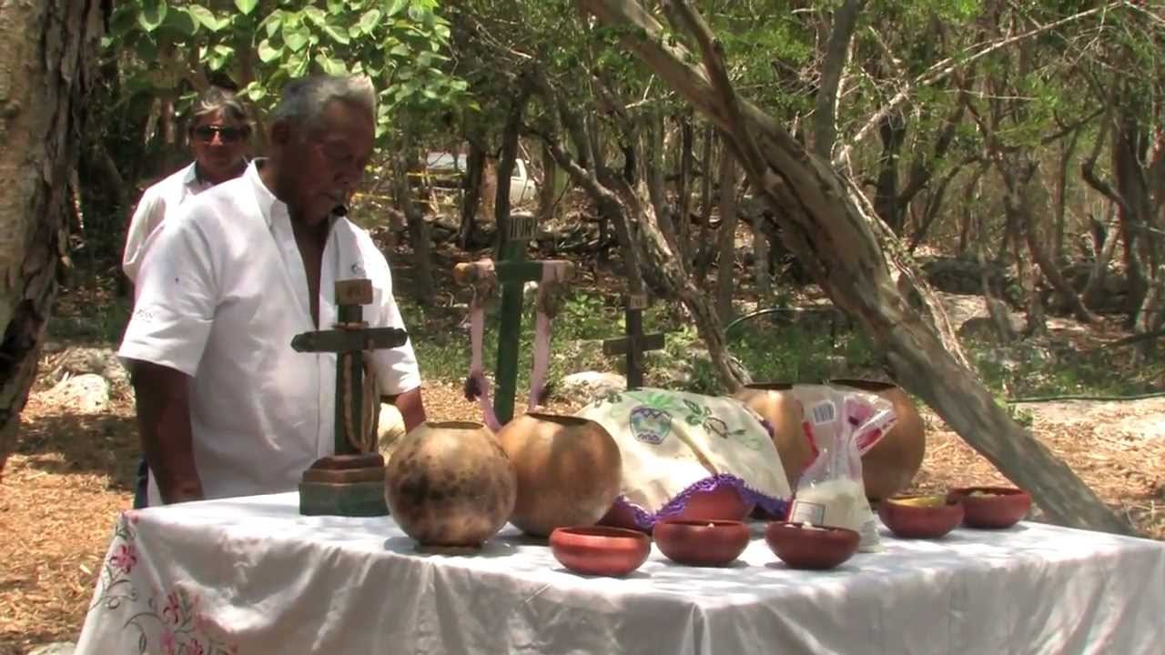 Participants gather around an altar during a traditional Maya ritual at the K'aan K'aan Che'e cenote in Homún, Yucatan