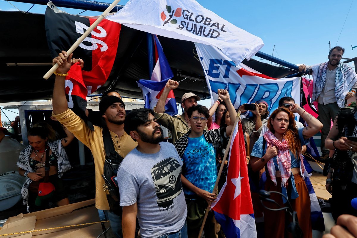 Activists wave goodbye to the Granma 2.0 aid ship departing from Chelem port in Yucatan, Mexico, bound for Cuba