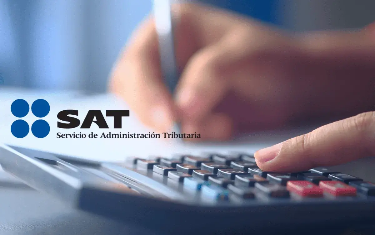 A person filing tax documents online with the SAT logo visible on the screen