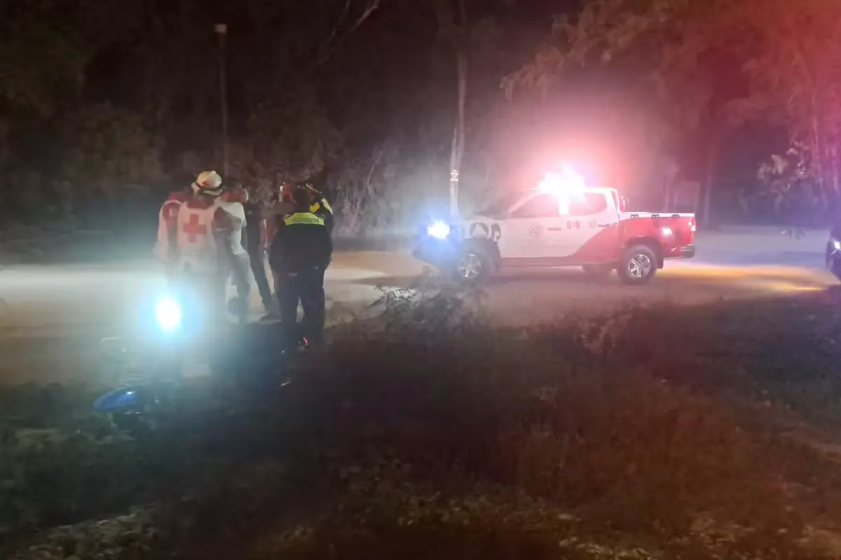 A motorcycle lying on a median in Tulum's La Veleta neighborhood after a crash