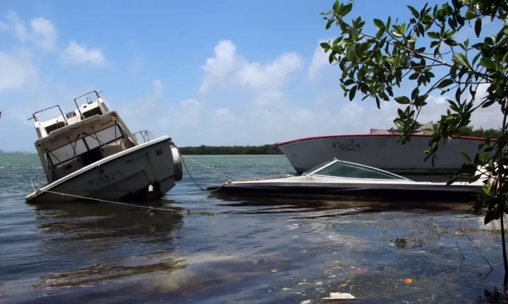 Specialized machinery being used to remove abandoned boats from Nichupté Lagoon in Cancún