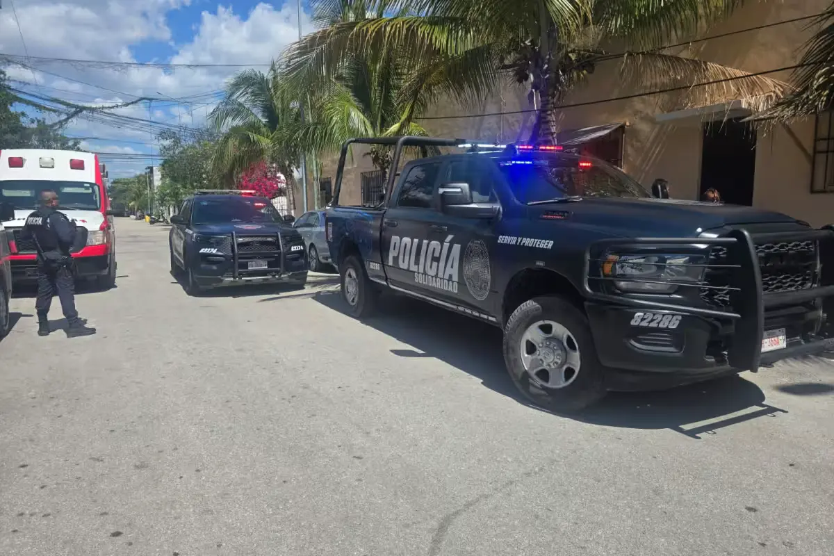 Paramedics providing prehospital care to an injured man lying on the ground