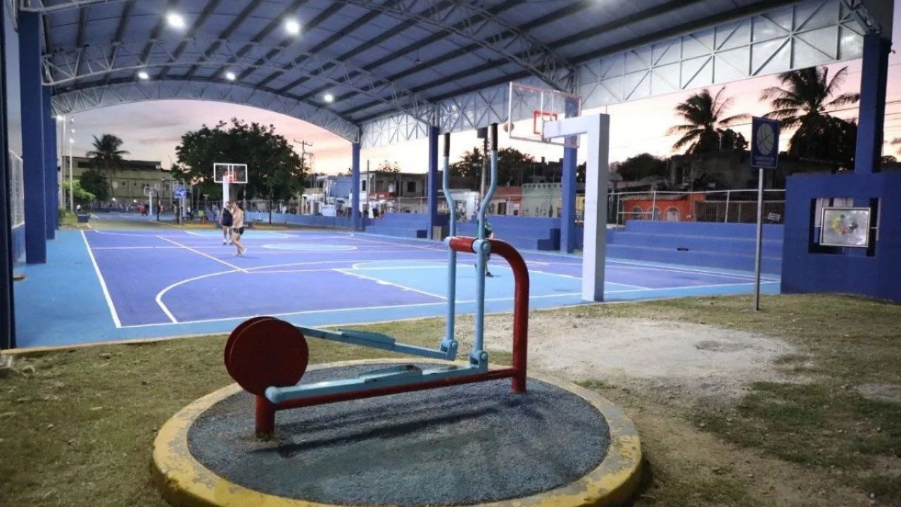 A view of Playa del Carmen's coastline under a clear blue sky with tourists enjoying the Caribbean Sea.