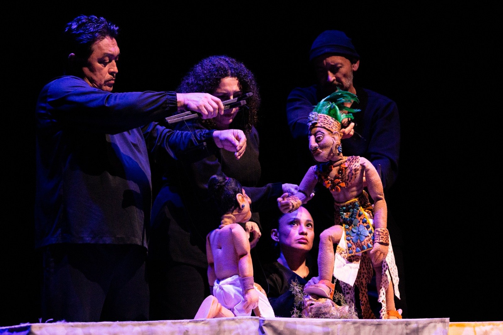 Audience members watch a puppet show at the Playa del Carmen International Theater Festival opening.