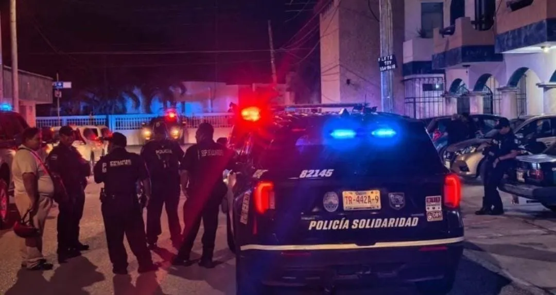 Police officers at a rooming house in Playa del Carmen where an elderly woman was found dead