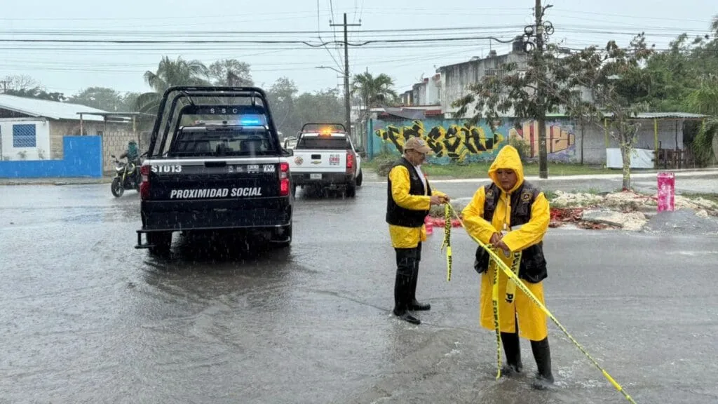 Emergency personnel working during heavy rains in Playa del Carmen