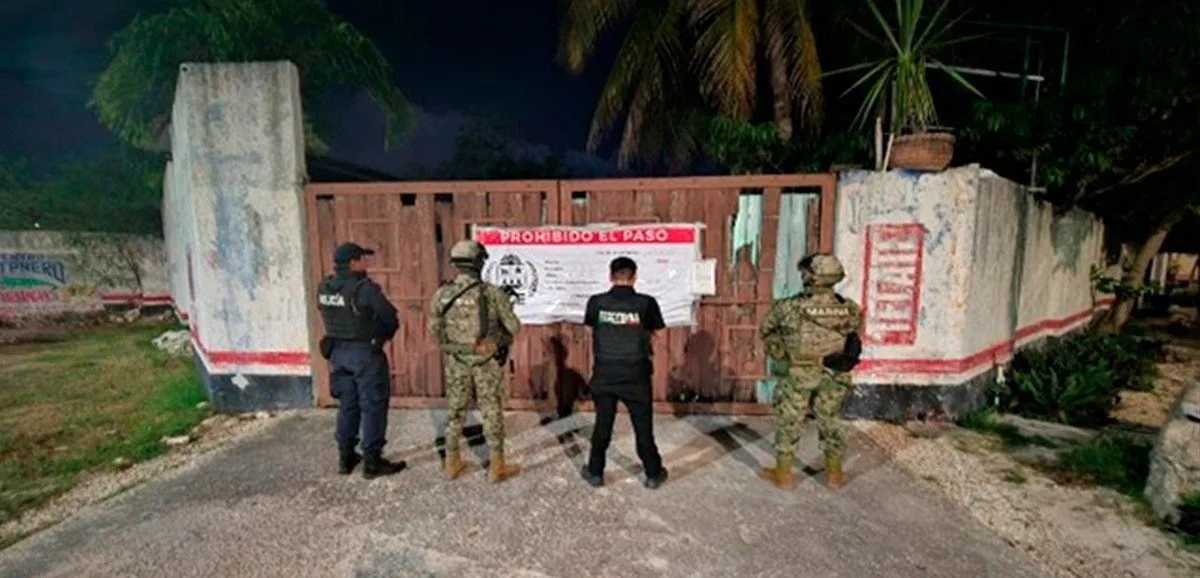 Police officers conducting an operation outside a bar in Cancún