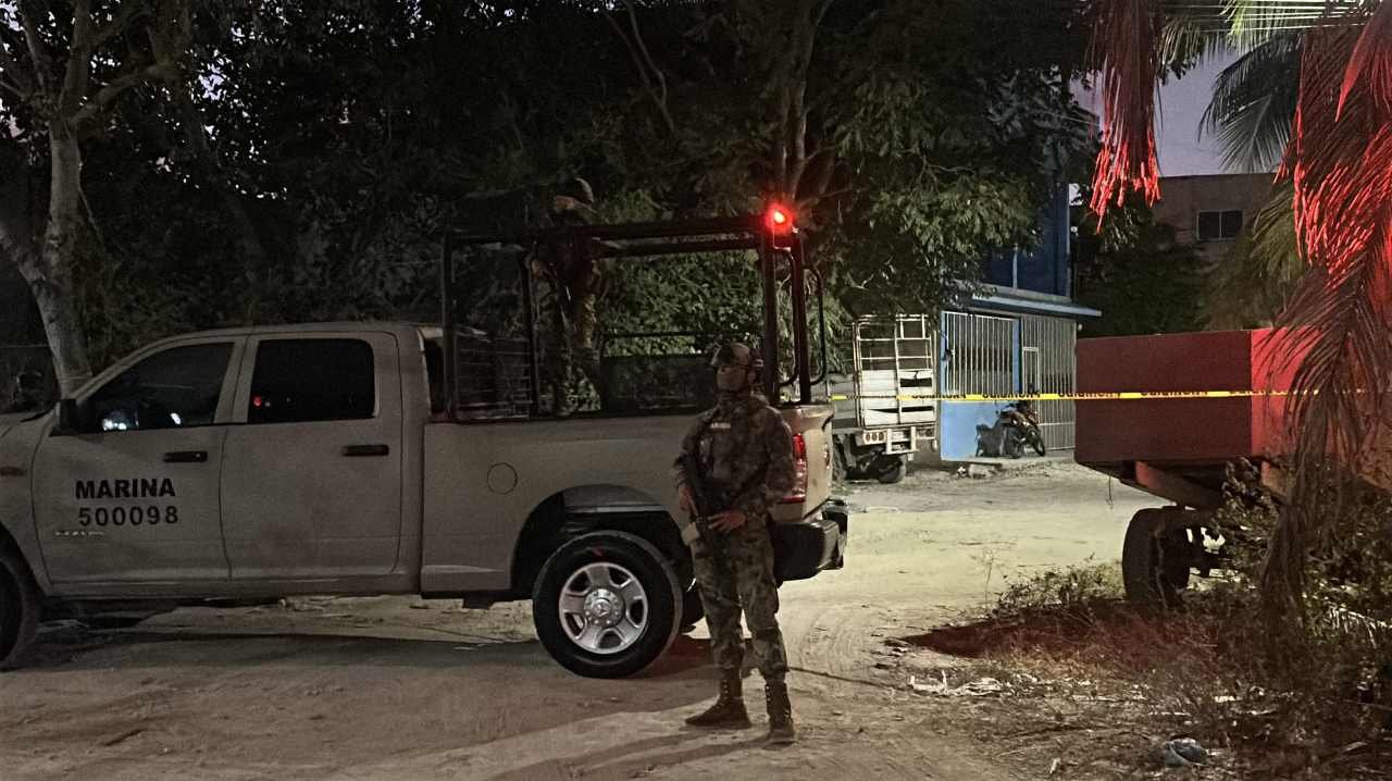 Police officers conducting a raid at the Caribeños bar in Cancún